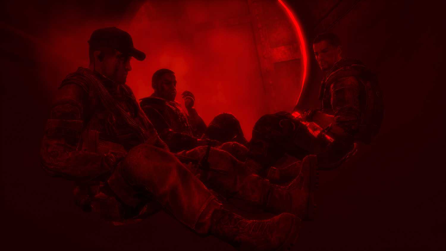 Martin Walker and his comrades sitting together, bathed in red light, in Spec Ops: The Line.