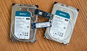 Synology hard drives or HDDs and SSDs lying on a desk