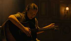 Ellie playing the guitar in HBO's The Last of Us, season 2, episode 5.