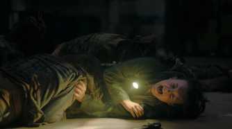 Ellie pinned down by stalkers in HBO's The Last of Us, season 2, episode 5.