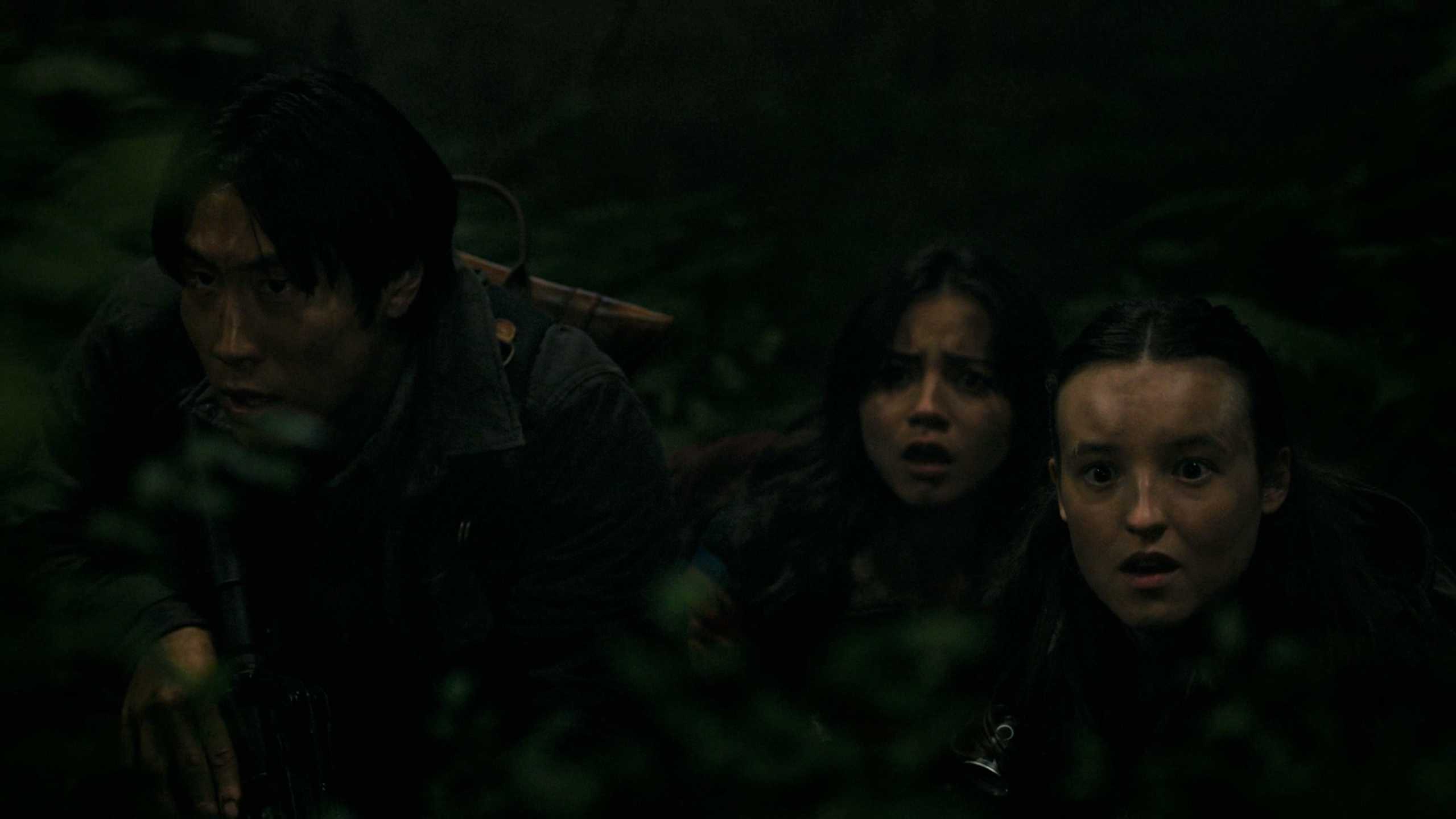Jesse, Dina, and Ellie looking afraid while hiding in HBO's The Last of Us, season 2, episode 5.