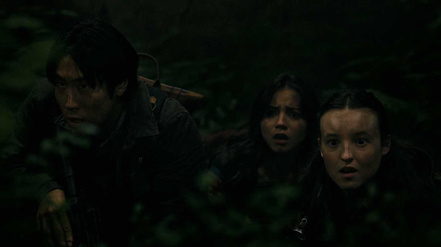 Jesse, Dina, and Ellie looking afraid while hiding in HBO's The Last of Us, season 2, episode 5.