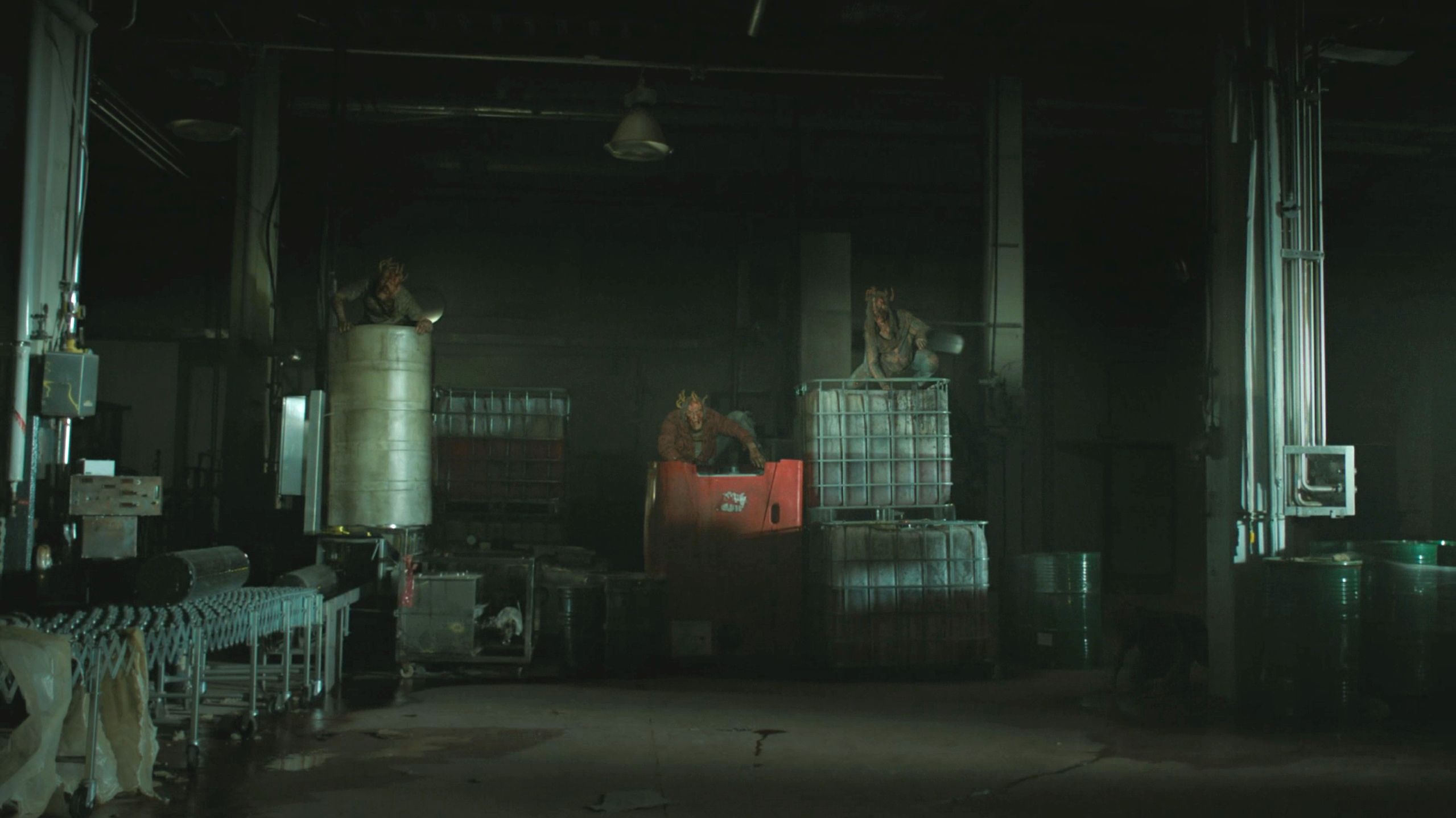 Mutliple stalkers sitting atop crates in HBO's The Last of Us, season 2, episode 5.