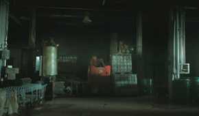 Mutliple stalkers sitting atop crates in HBO's The Last of Us, season 2, episode 5.