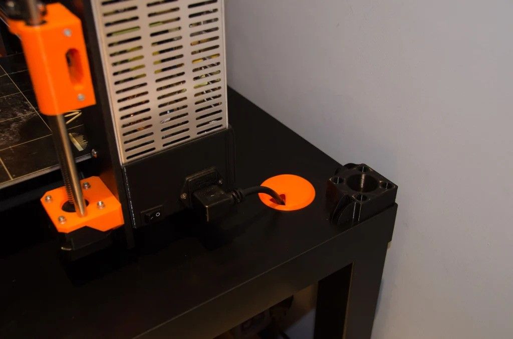 orange cable grommet in a black table