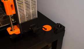 orange cable grommet in a black table