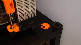 orange cable grommet in a black table
