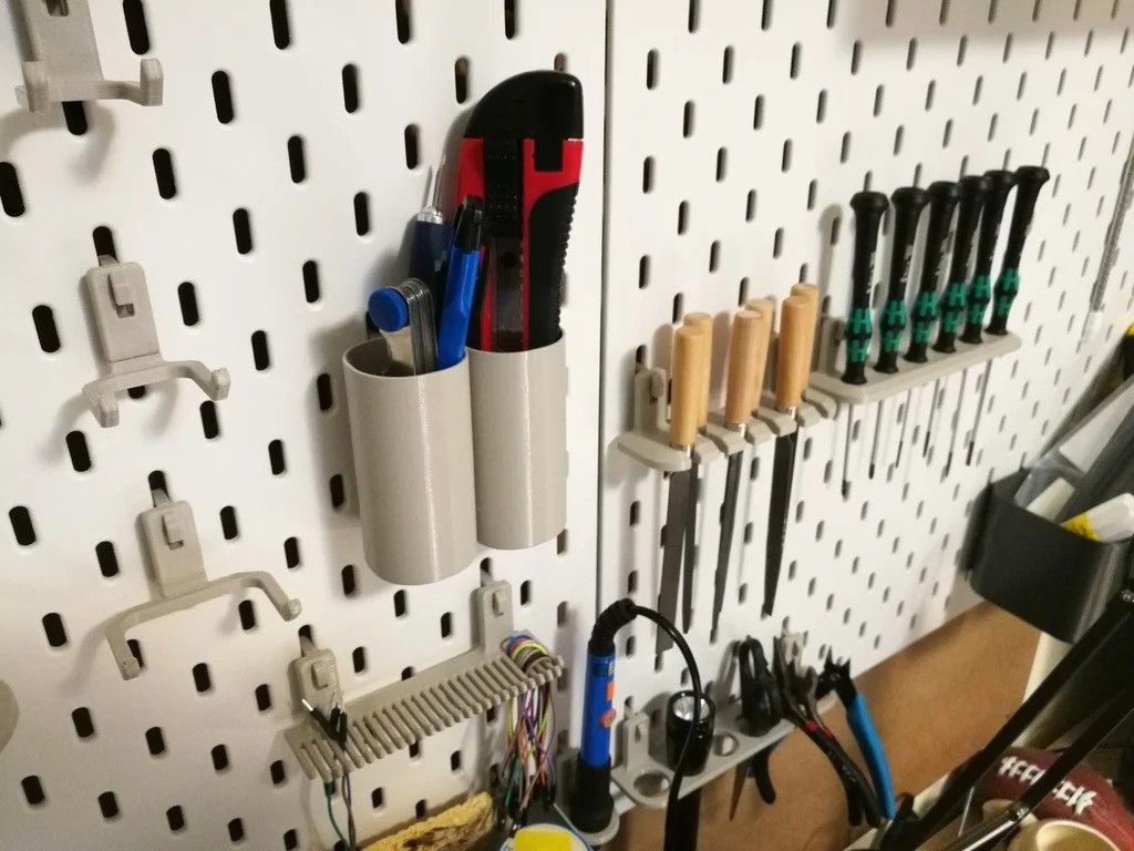 close-up shot of a box cutter and wood files in dedicated holders on an IKEA pegboard