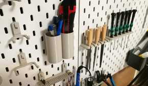 close-up shot of a box cutter and wood files in dedicated holders on an IKEA pegboard