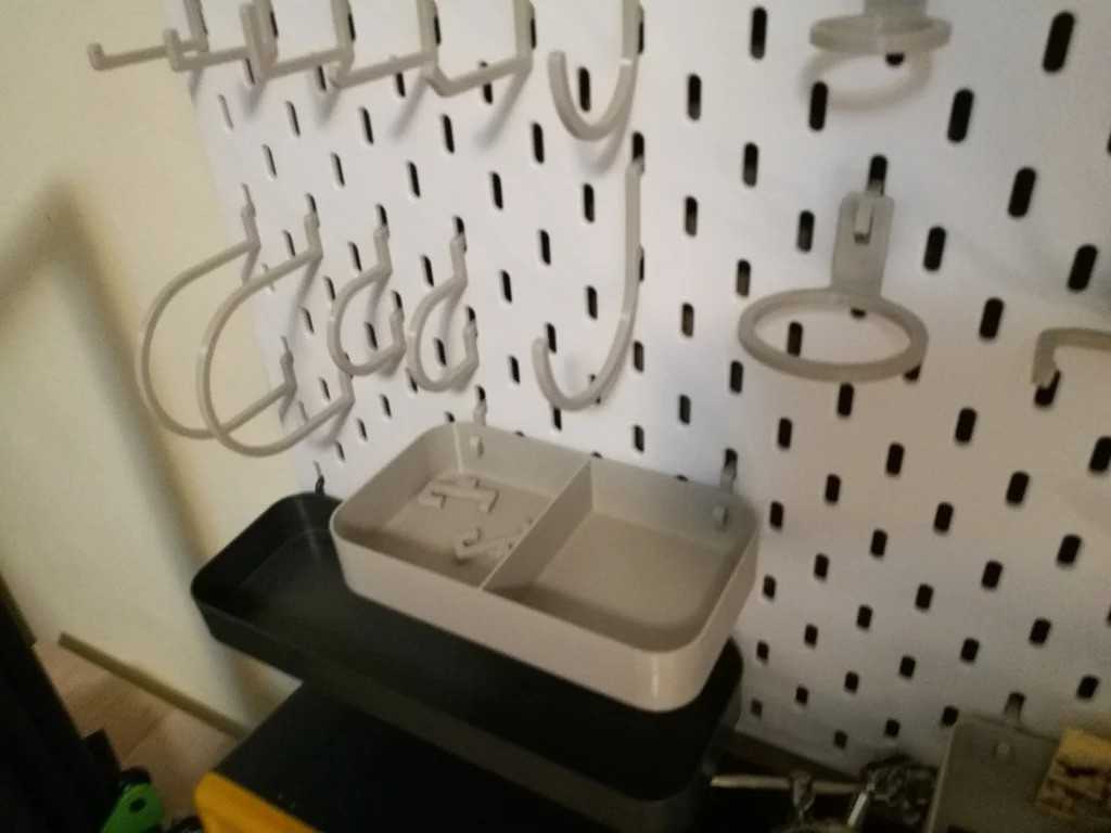close-up shot of a parts tray and various hooks on an IKEA pegboard