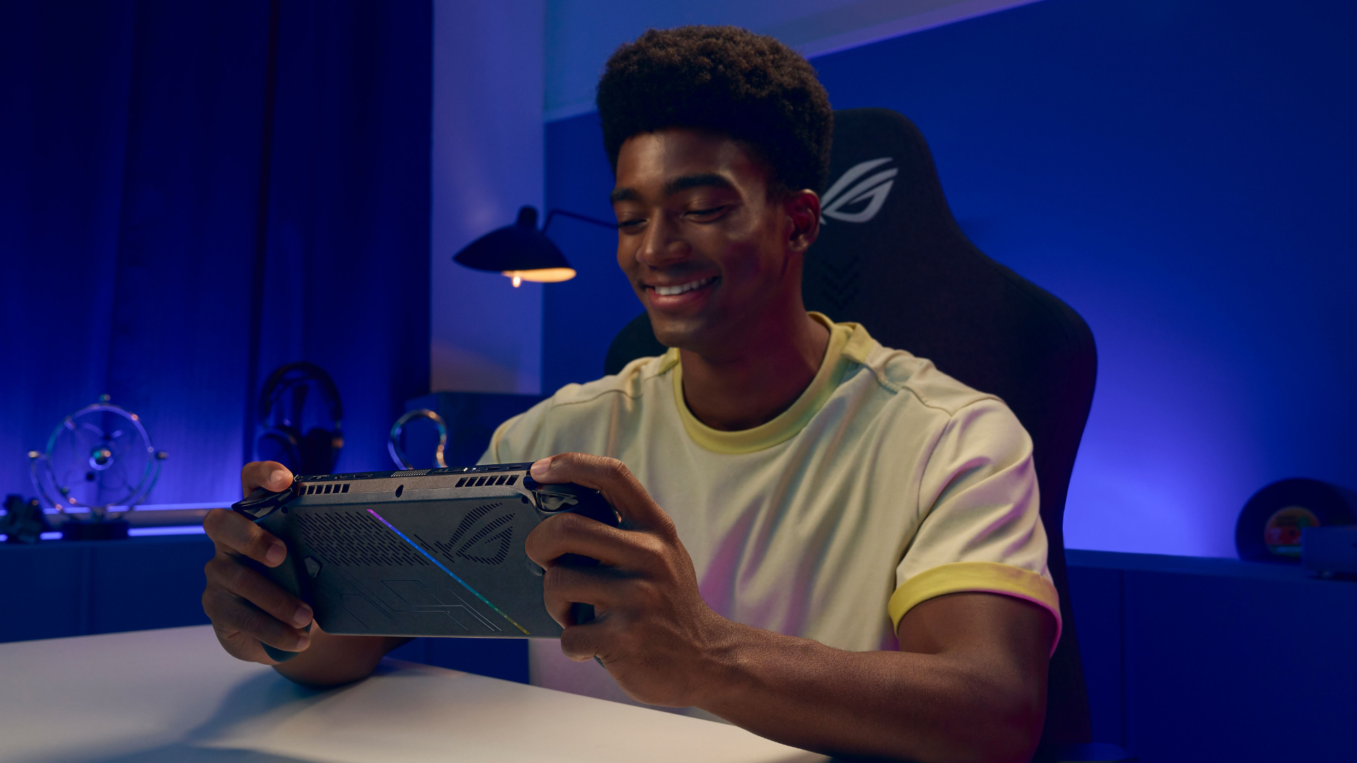 A man playing on the Xbox Ally X at a desk