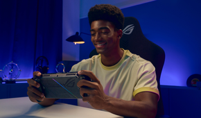 A man playing on the Xbox Ally X at a desk