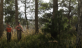 Two men walking through a forrest