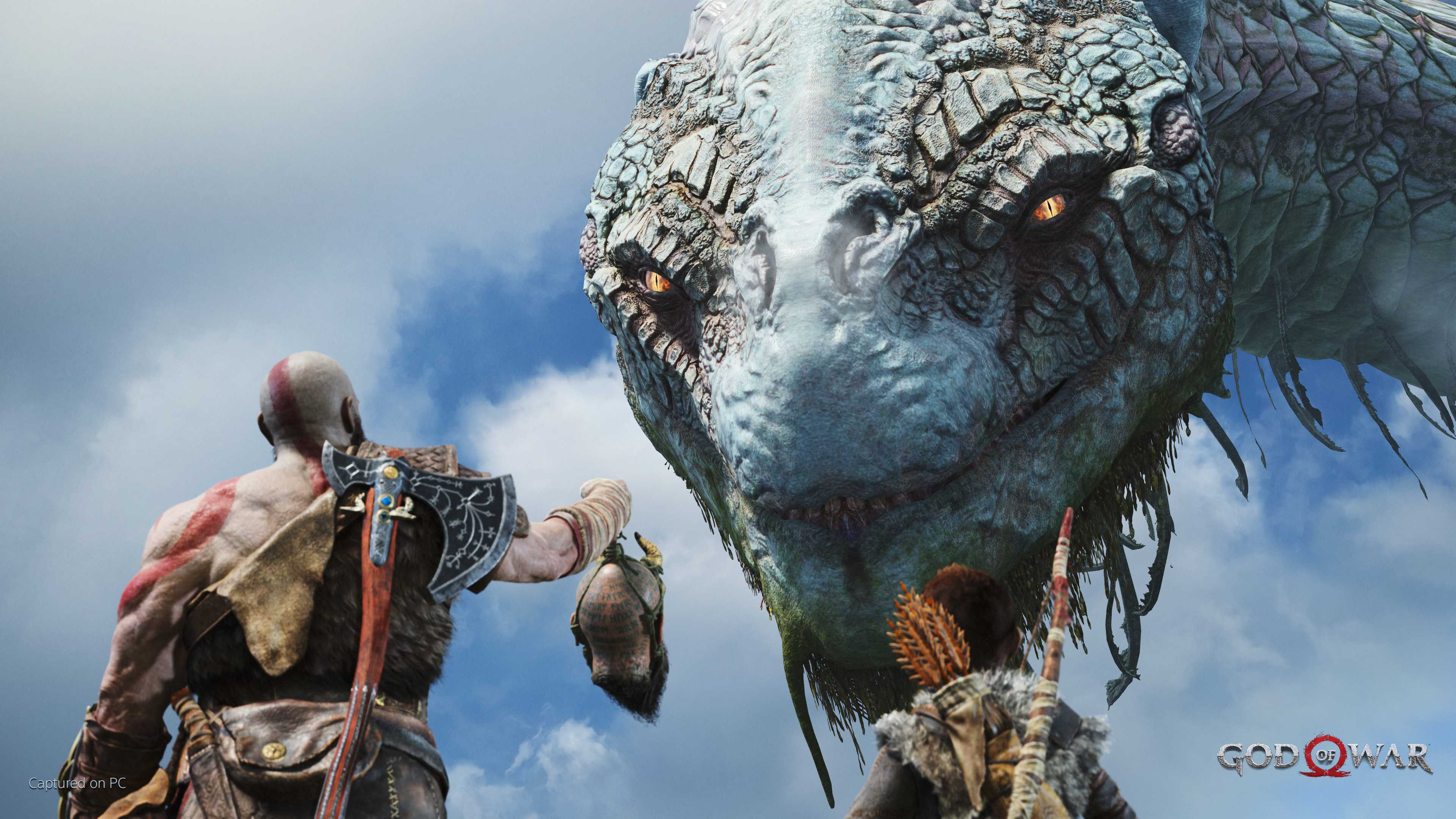 Kratos holding up Mimir's head to Jormungandr in 2018's God of War.