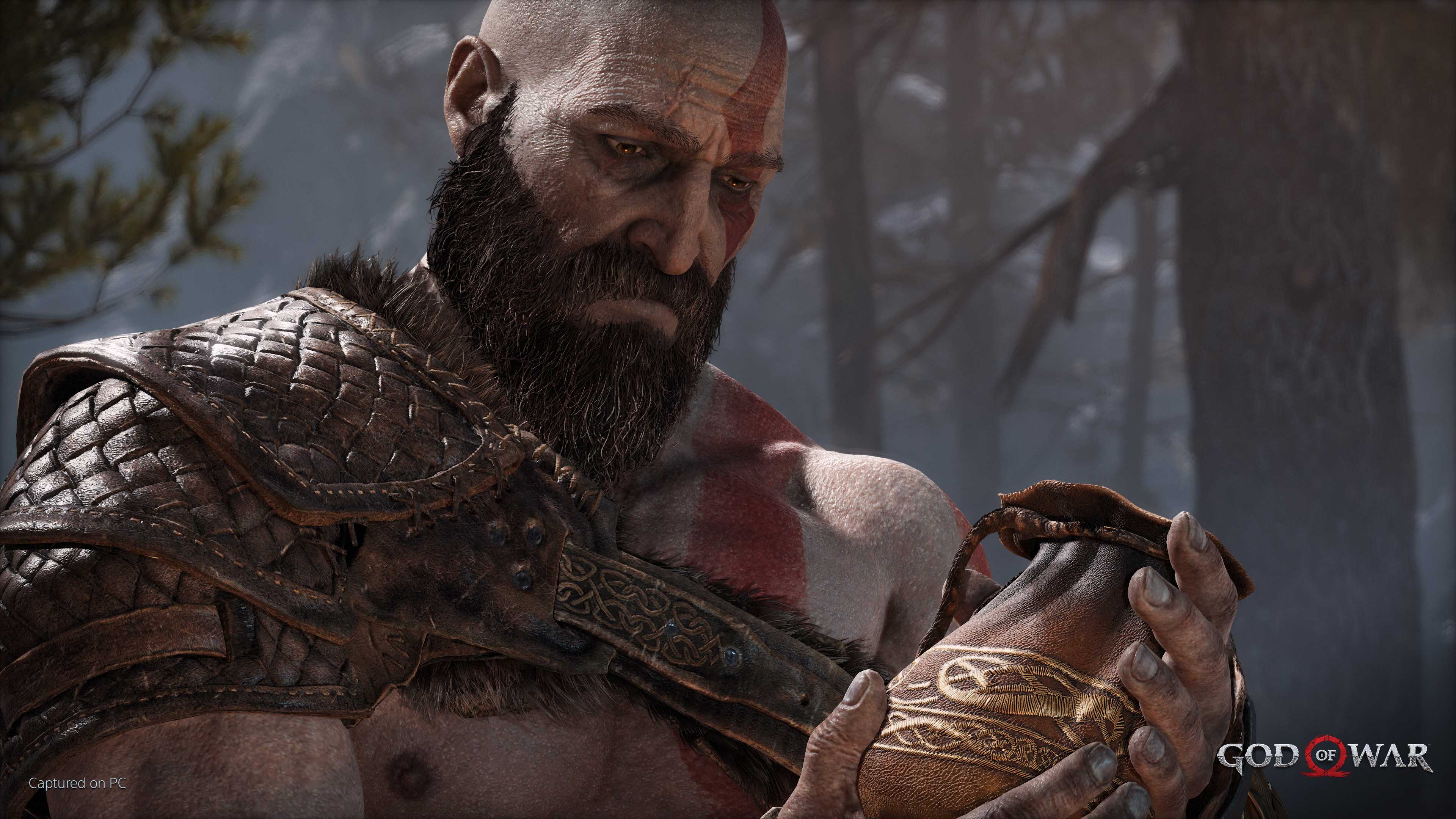 Kratos holding his wife's ashes in 2018's God of War.