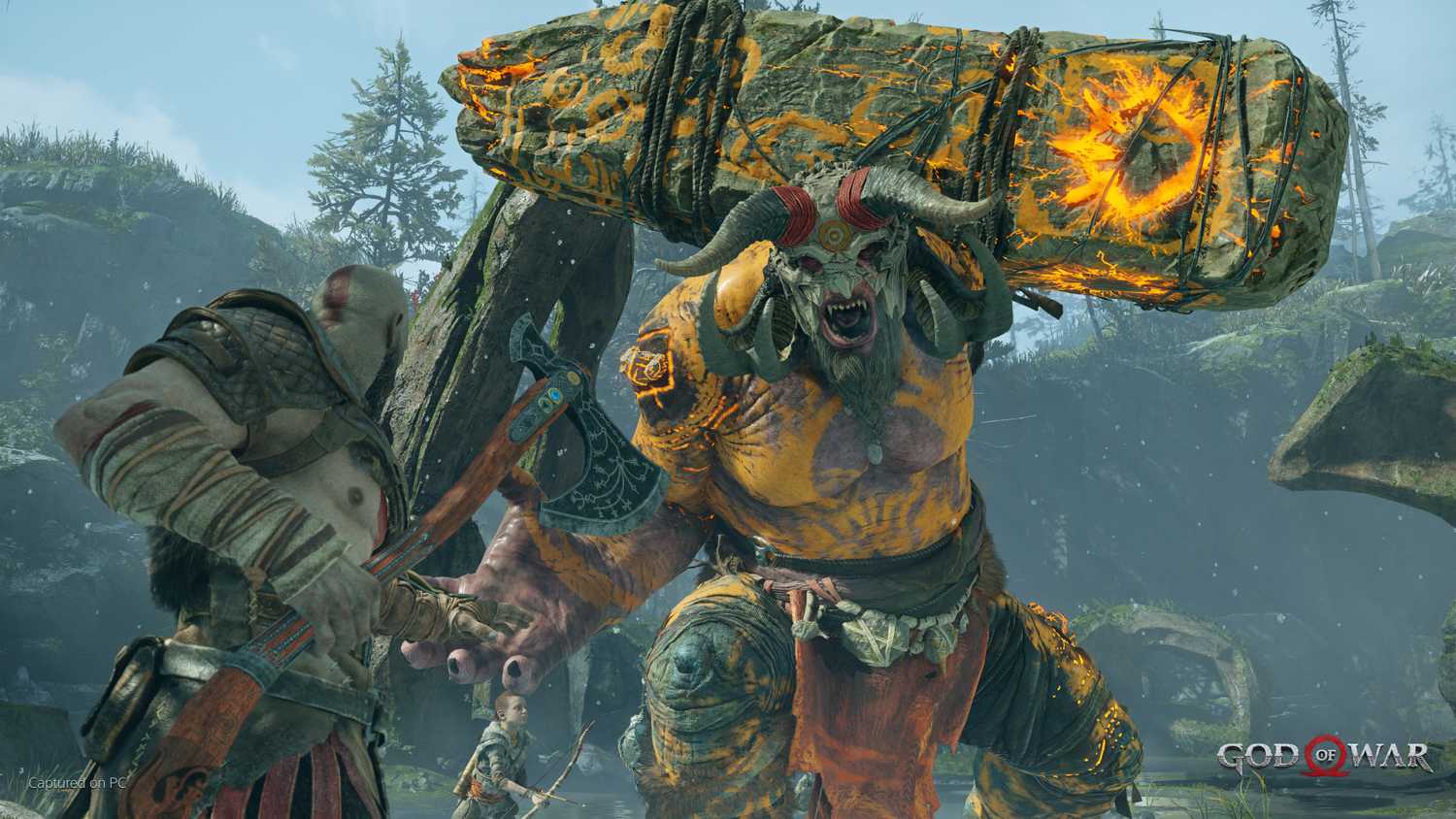 Kratos fighting an ogre in 2018's God of War.