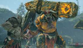 Kratos fighting an ogre in 2018's God of War.