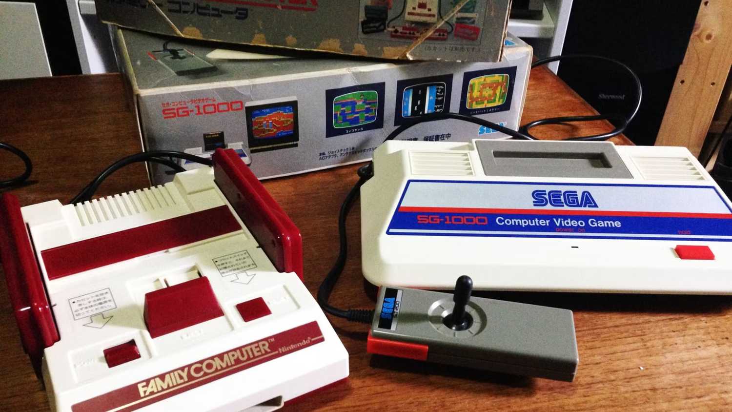 A picture of the Sega SG-1000 next to a Famicom.