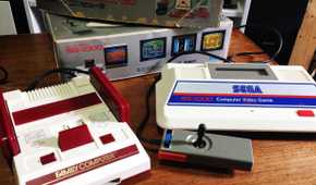 A picture of the Sega SG-1000 next to a Famicom.