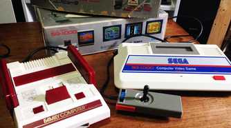 A picture of the Sega SG-1000 next to a Famicom.