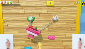 Screenshot of Super Mario Party Jamboree Nintendo Switch 2 Edition during a rock-climbing minigame with a small view of the player suing one of the Joy-Con 2 as a mouse