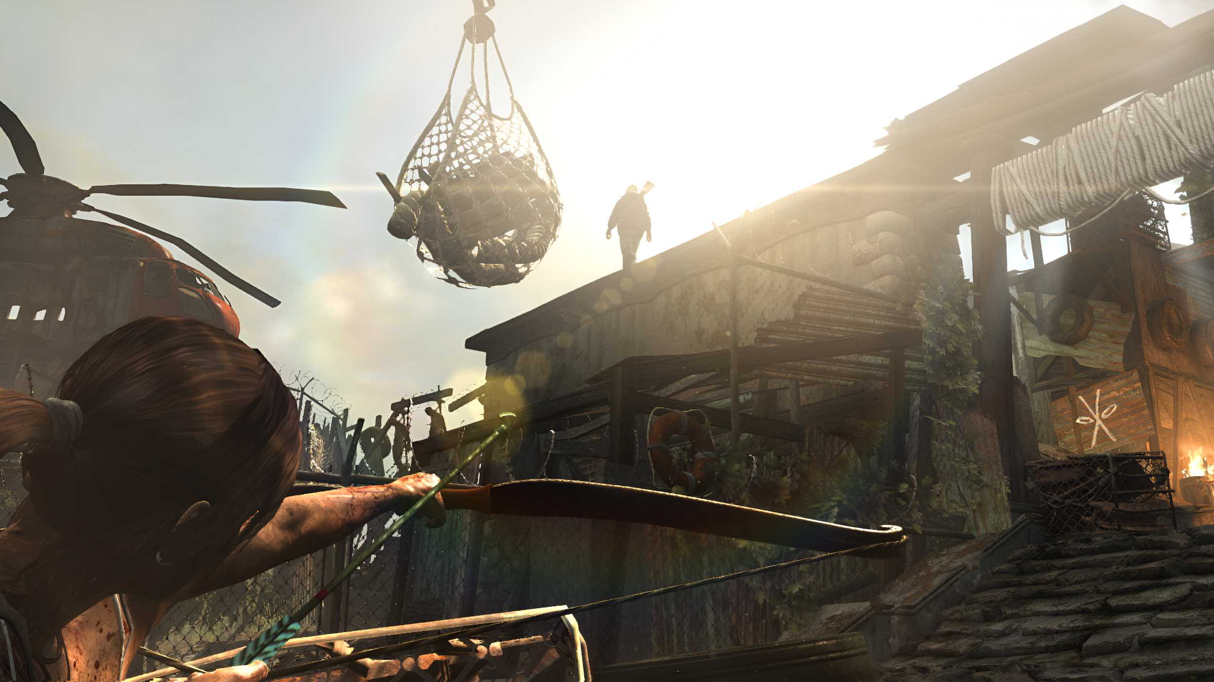 Lara Croft aiming an arrow at an enemy overhead in 2013's Tomb Raider.