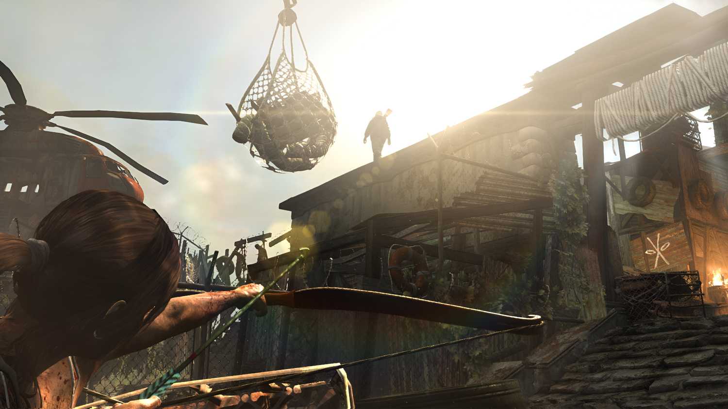 Lara Croft aiming an arrow at an enemy overhead in 2013's Tomb Raider.