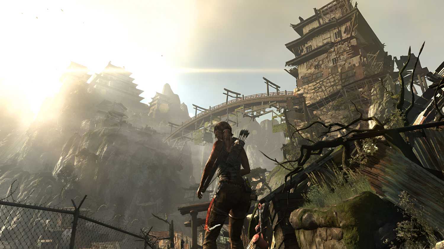 Lara Croft looking at a huge wooden bridge overhead in 2013's Tomb Raider.