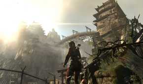Lara Croft looking at a huge wooden bridge overhead in 2013's Tomb Raider.