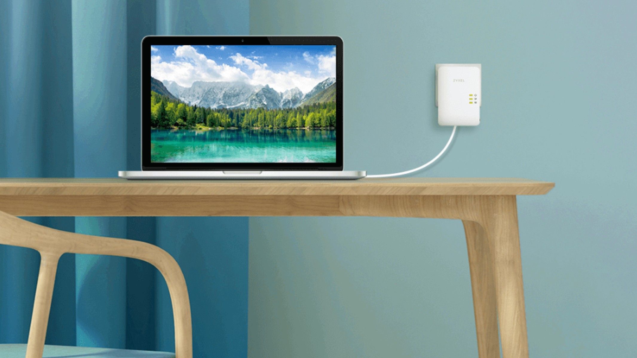 zyxel powerline adapter plugged into the wall with an ethernet cable going to the laptop