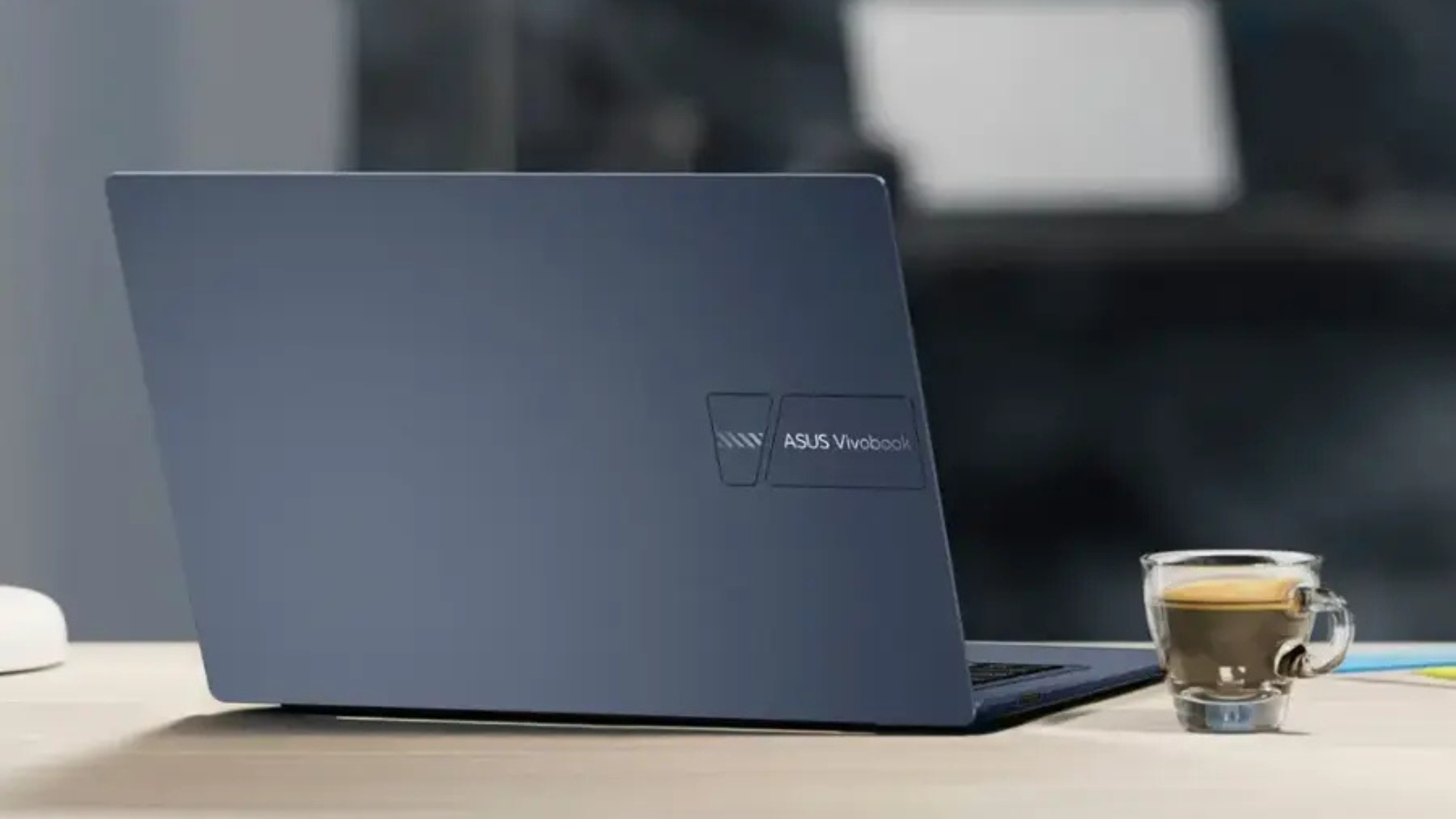Asus Vivobook 14 on desk next to coffee