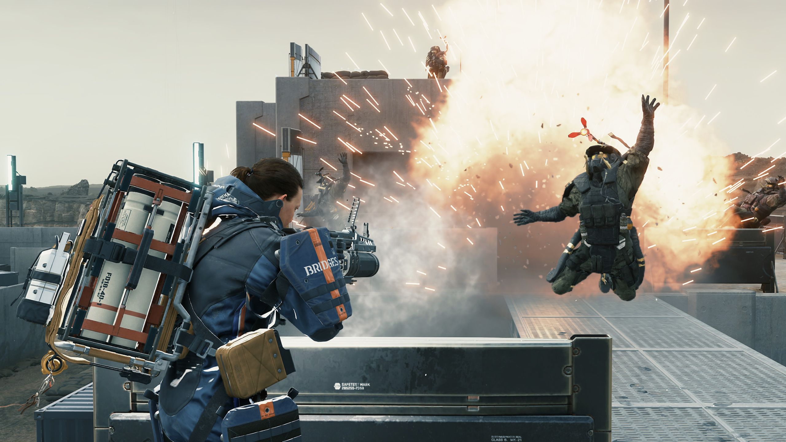 Sam Porter Bridges causing an explosion in a mule outpost in Death Stranding: Director's Cut.