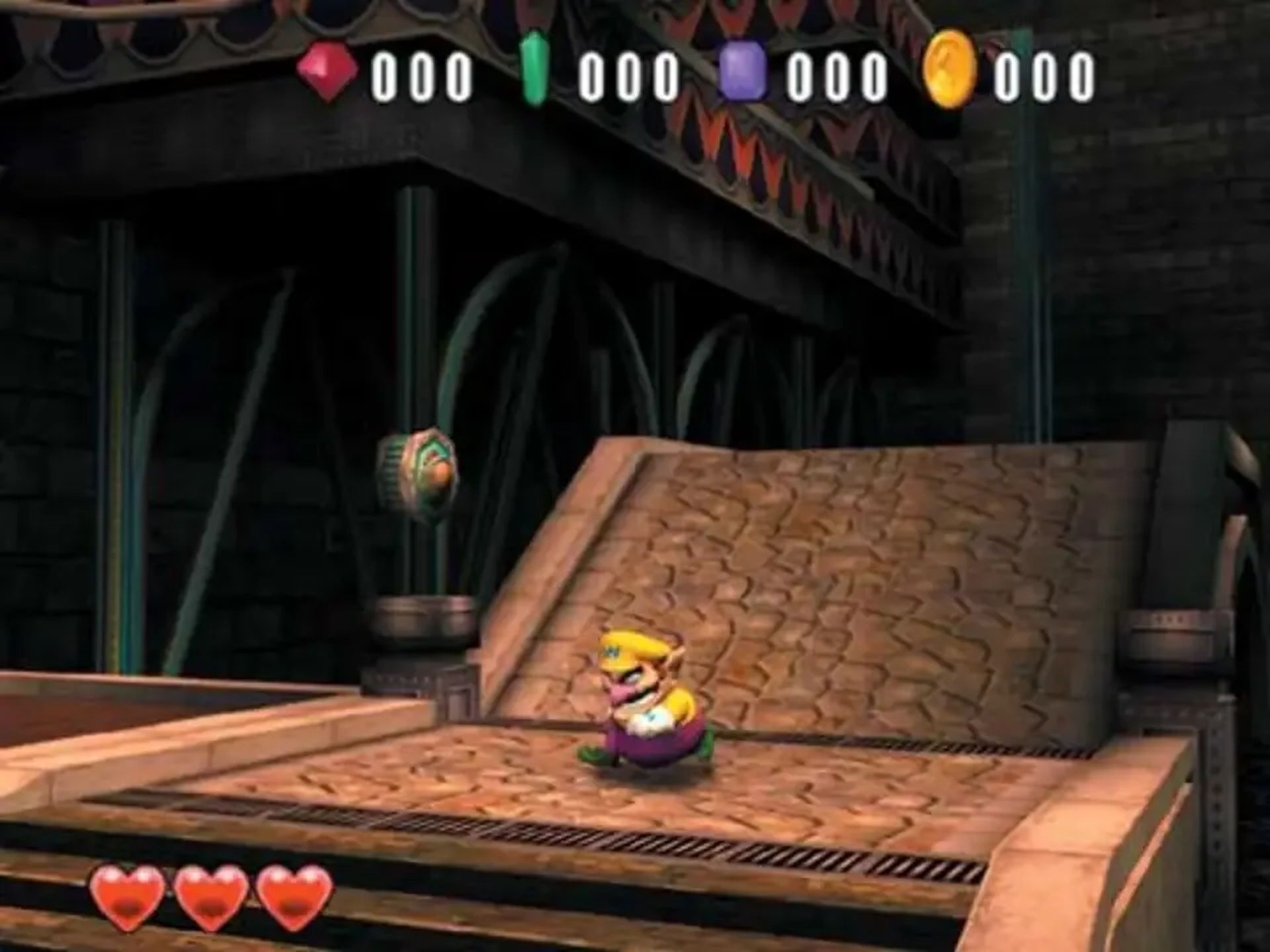 A screenshot of Wario roaming around a stage in Wario World.