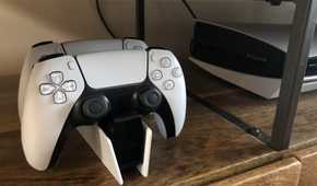 A shot of the PlayStation DualSense Charging Station next to a PlayStation 5