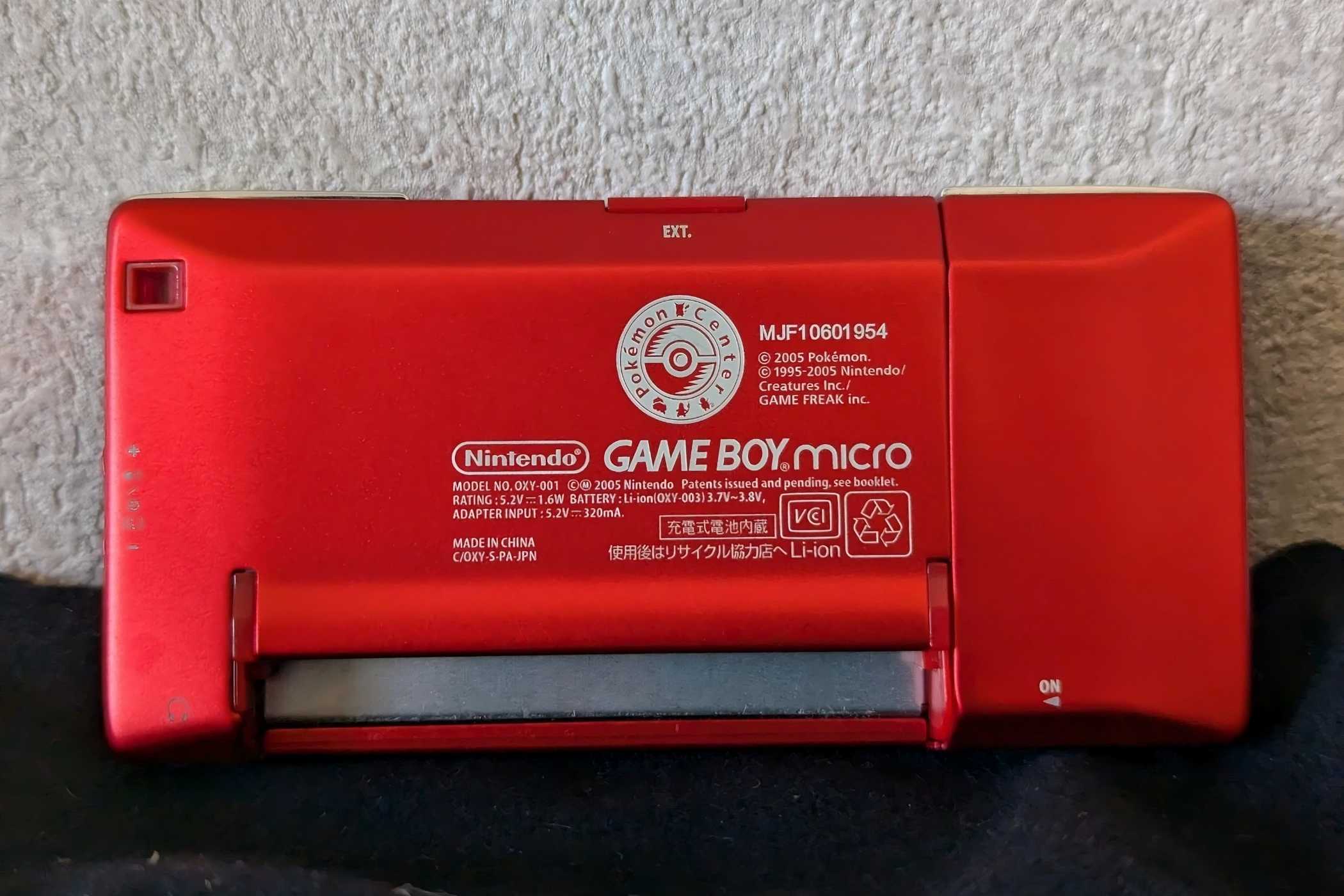 The backside of a red Game Boy Micro from the Japan Pokemon Center.