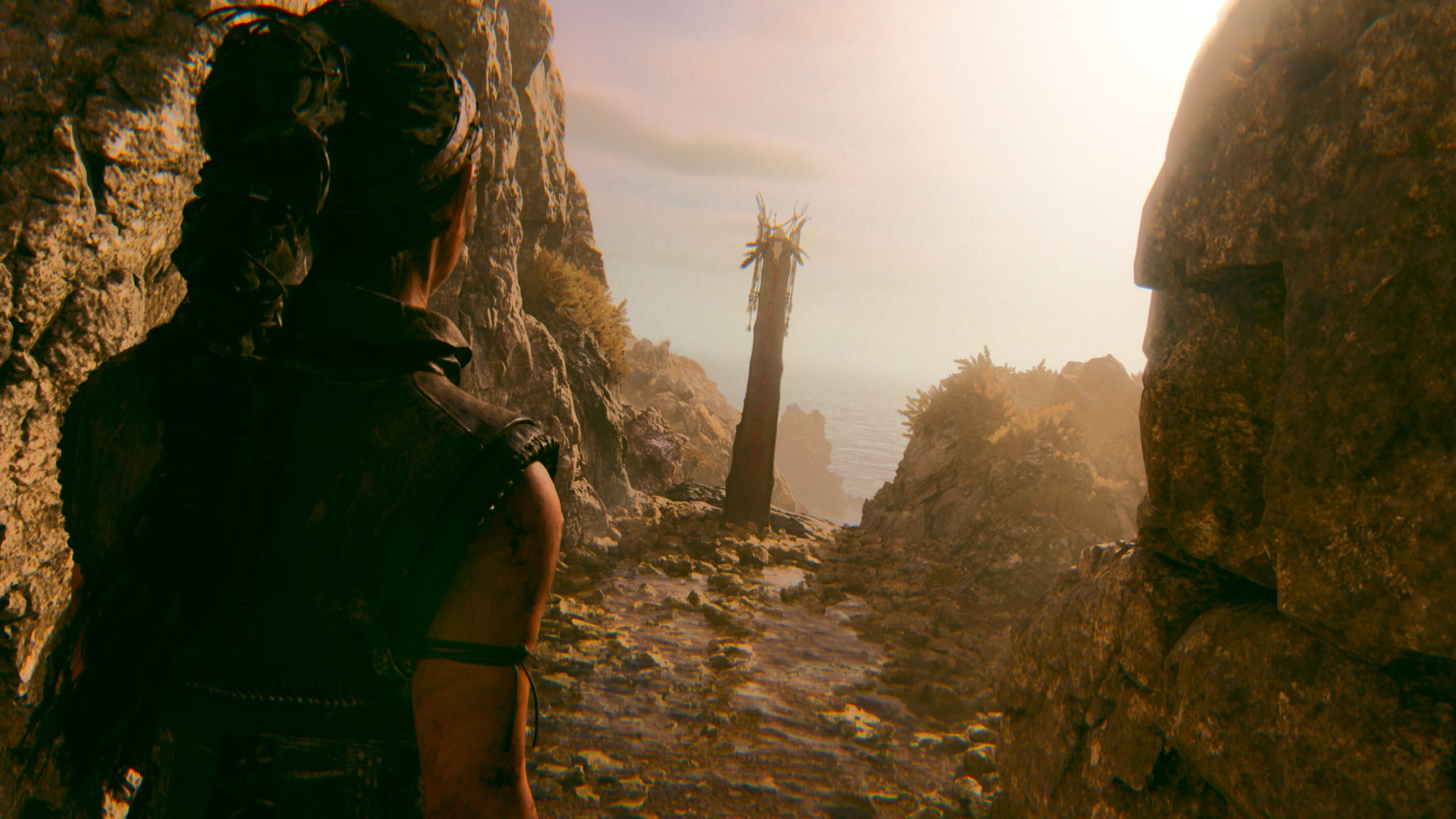 A screenshot of Senua walking up to a pillar in Senua's Saga: Hellblade II.