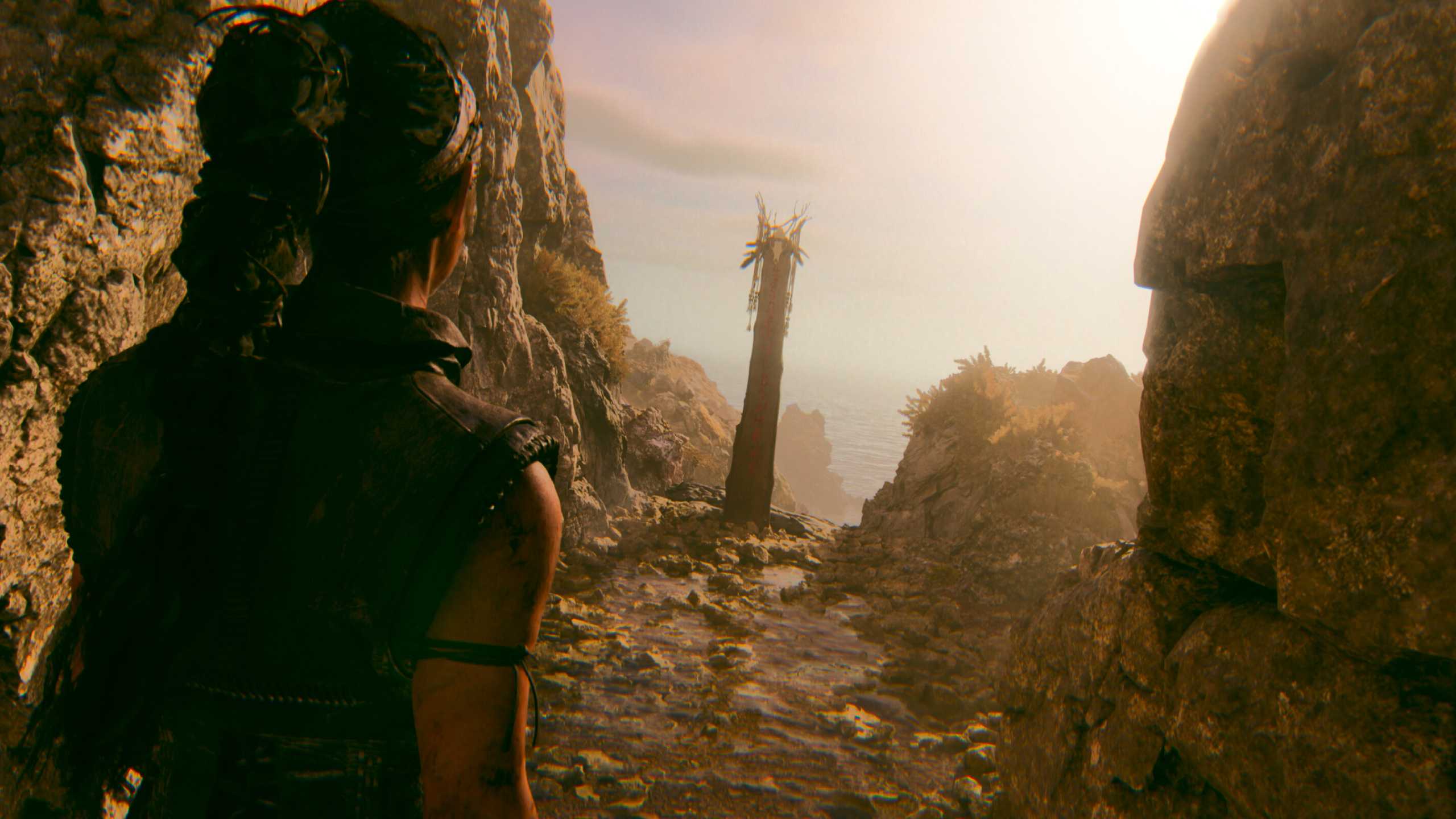 A screenshot of Senua walking up to a pillar in Senua's Saga: Hellblade II.