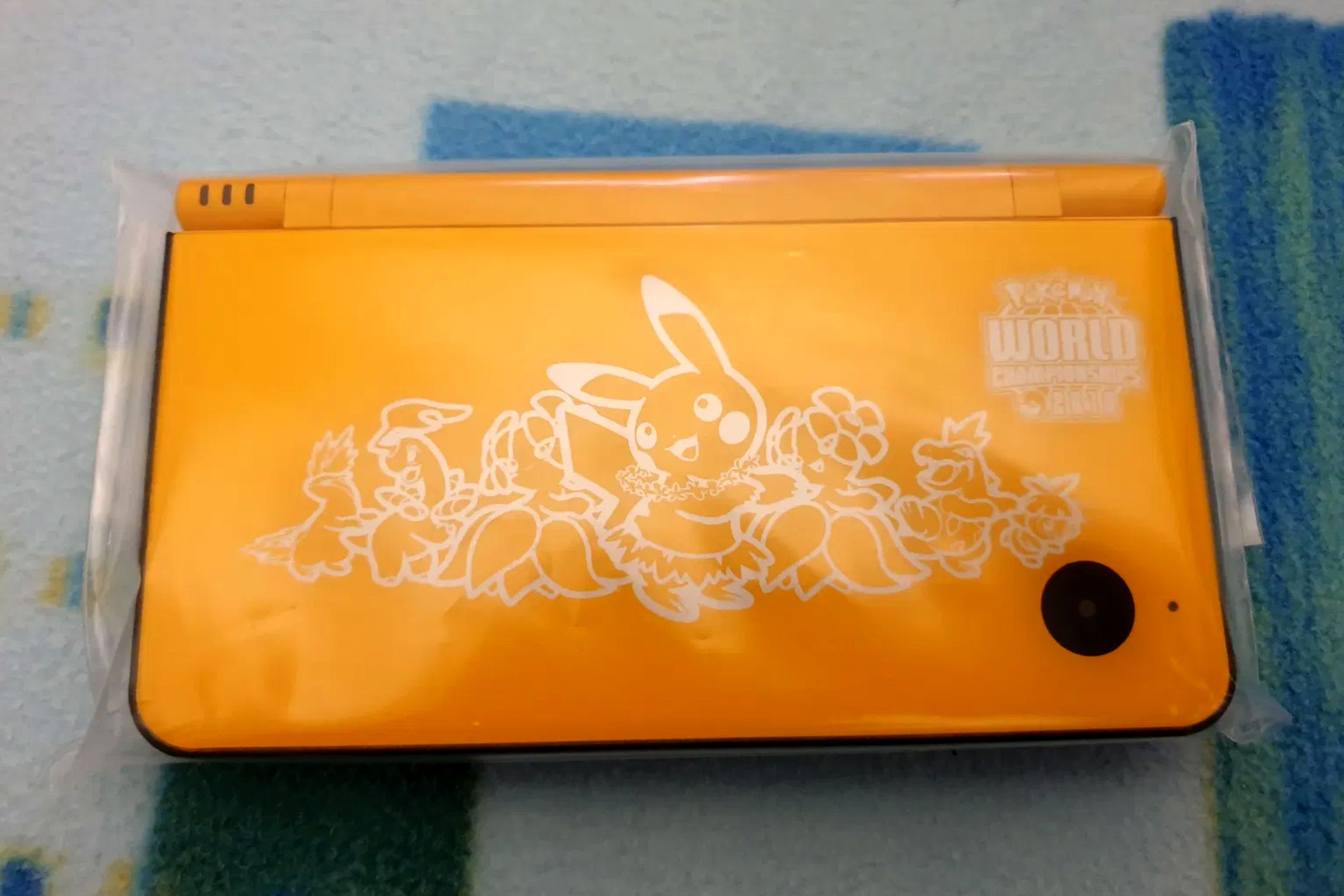 A folded yellow Nintendo DSi XL from the 2010 Pokemon World Championships.