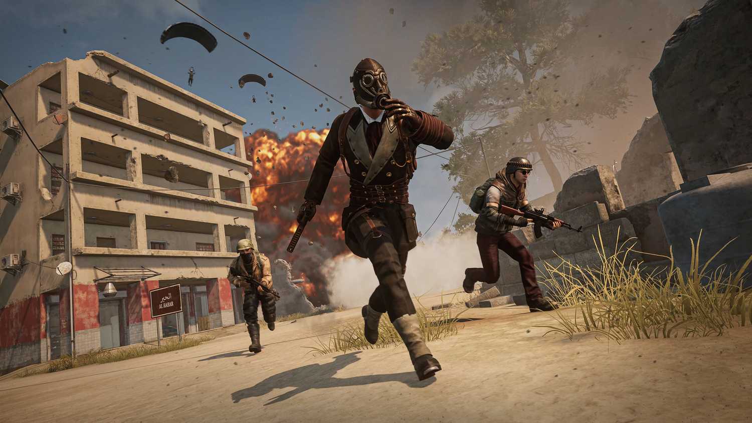 A trio of players running from an exploding building in PlayerUnknown's BattleGrounds.
