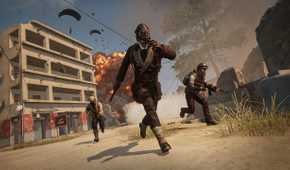 A trio of players running from an exploding building in PlayerUnknown's BattleGrounds.