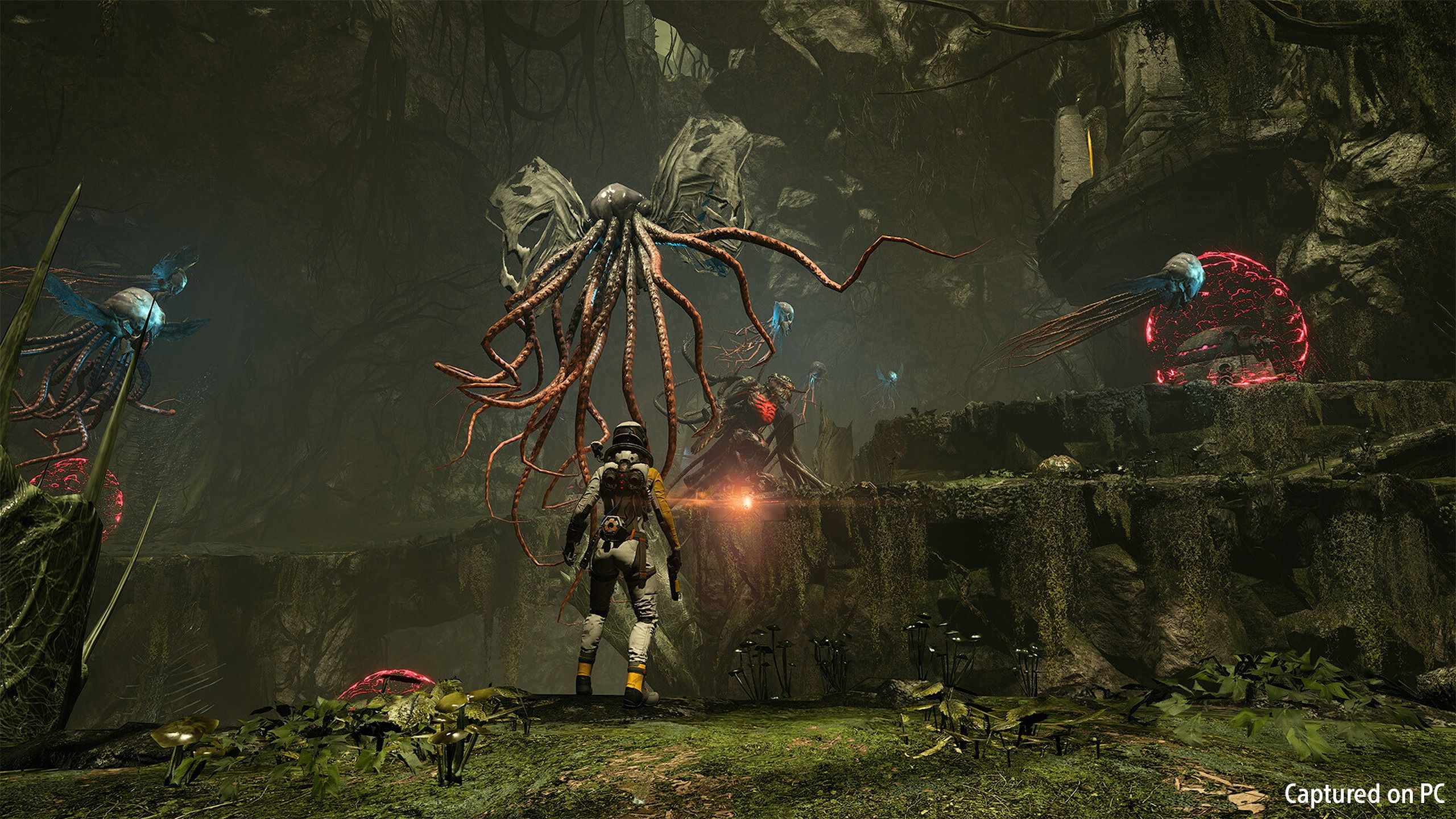 Selene facing off against flying Lovecraftian creatures in Returnal.