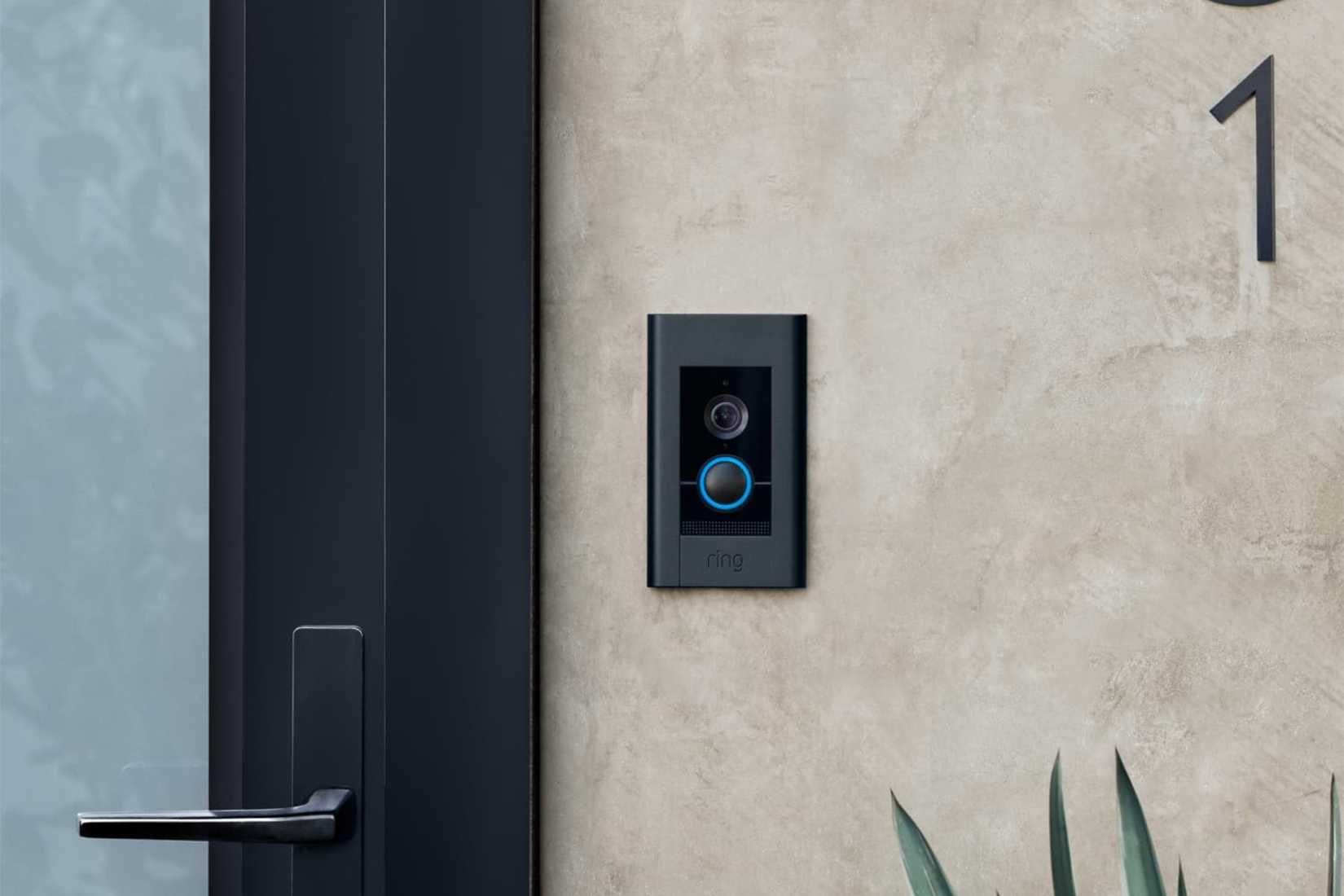 ring video doorbell elite mounted on wall next to door