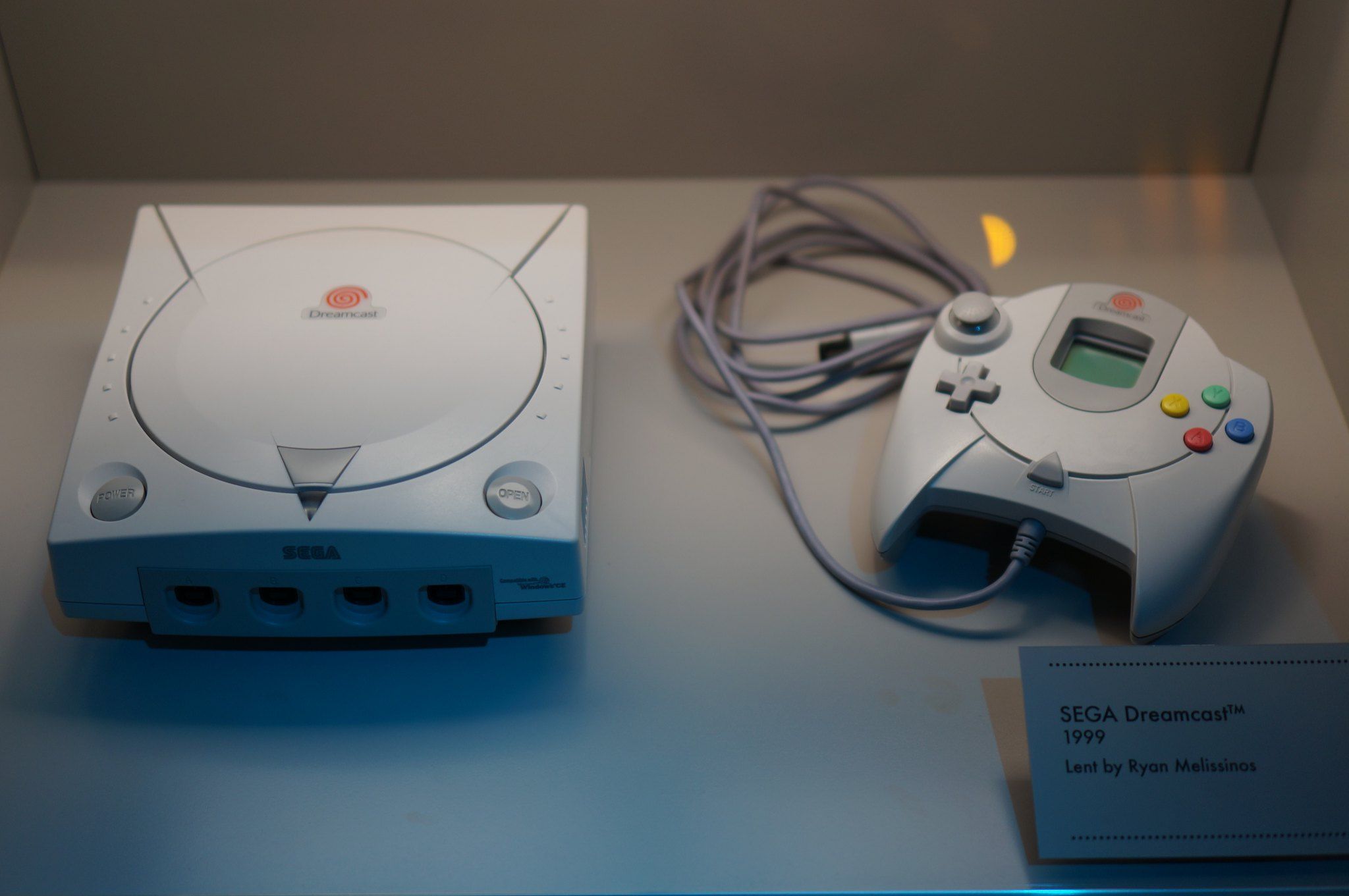 A Sega Dreamcast and its controller.
