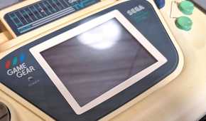 A close-up of a Sega Game Gear white edition.