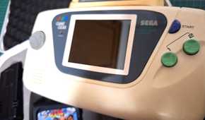 A close-up of a Sega Game Gear white edition.
