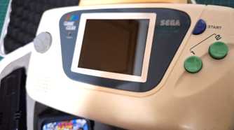 A close-up of a Sega Game Gear white edition.