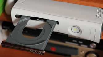 The disc tray of the Xbox 360 open.
