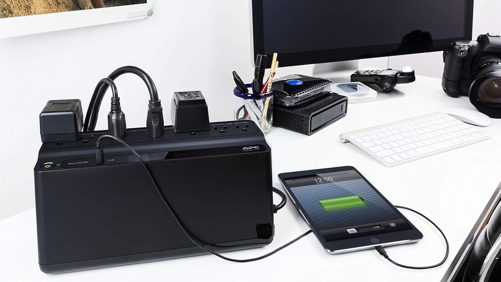 APC UPS Battery Backup and Surge Protector plugged into tablet and other devices