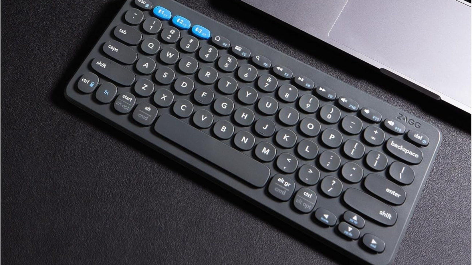 ZAGG Pro Keyboard 12 on desk next to laptop