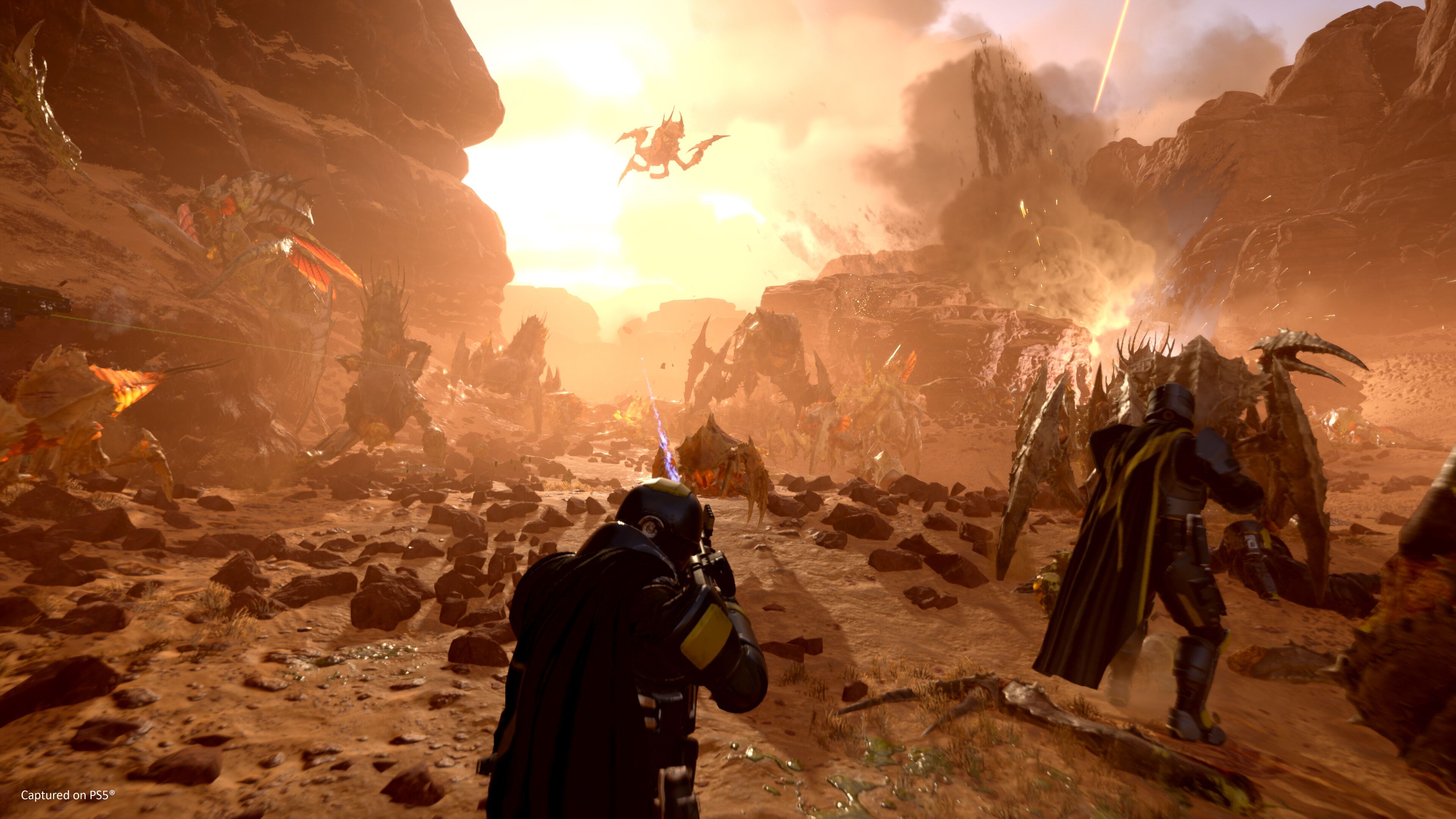 Helldivers on a desert planet while the sun sets.
